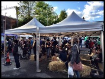 shoppers resting on hay bales at Levy night market