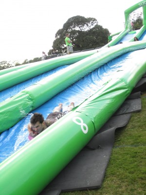 man taking on Slide the City face first