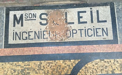 Mosaic shop names in Paris arcade